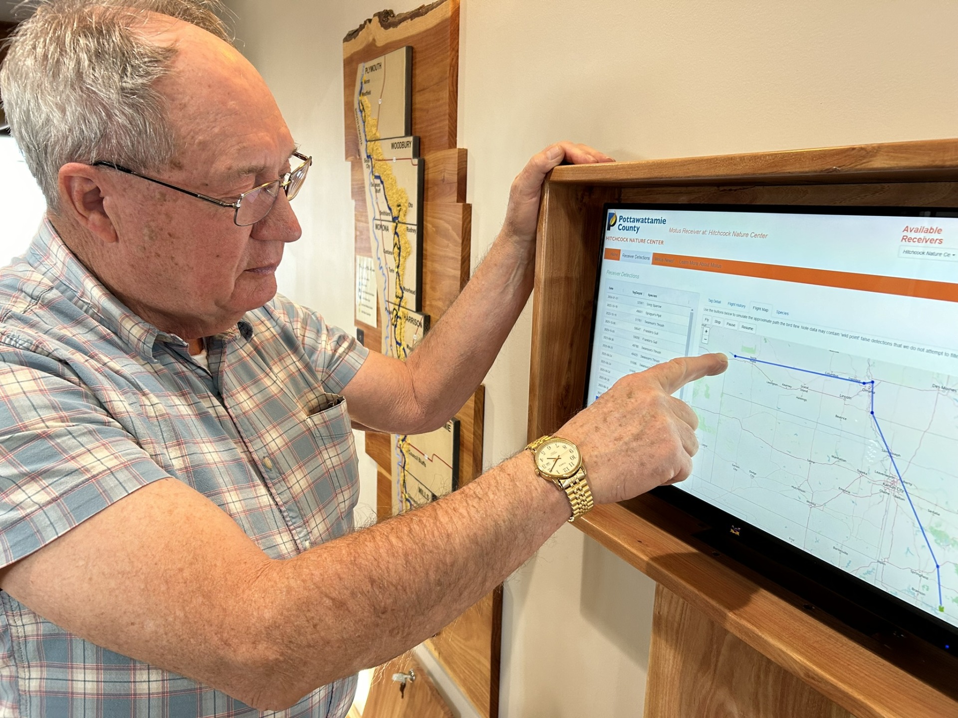 Glenn demonstrates how to use the new Motus display at Hitchcock Nature Center's Loess Hills Lodge.